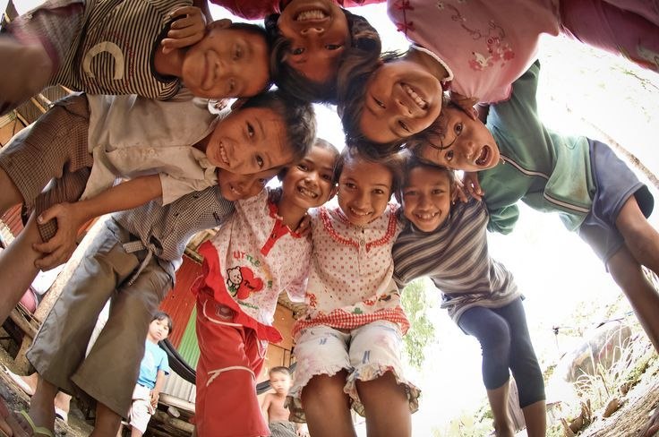 Children gathering together in a circle and smiling