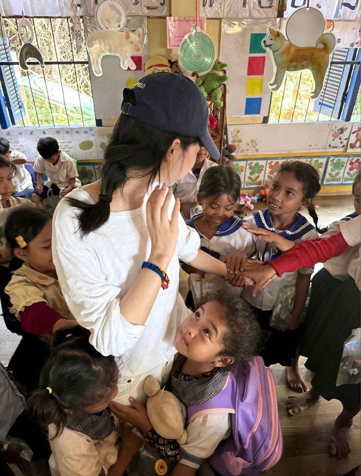A volunteer supporting children in a learning space