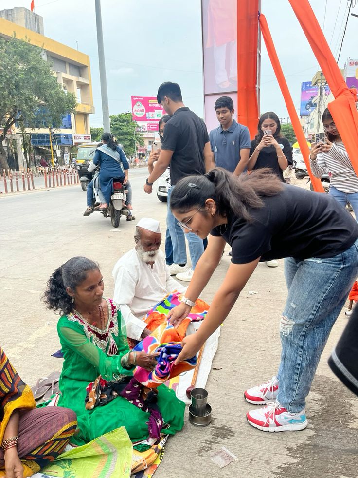 A volunteer offering clothing to a neighbour