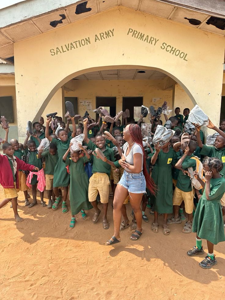 Schoolchildren celebrating together outside their school